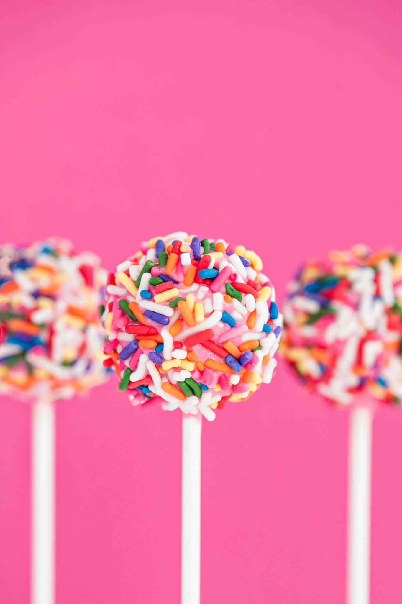 Homemade Strawberry Cake Pops With Sprinkles On Pink Backgroun